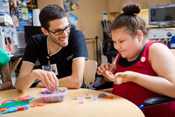 Arts and crafts with child in wheelchair and child life specialist