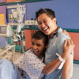 Child patient embracing medical staff member